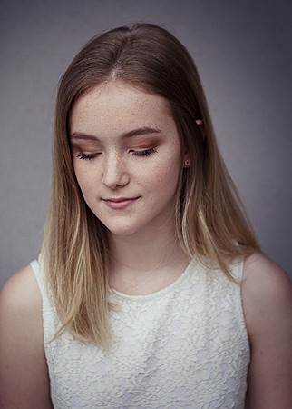 A young women looks down from camera